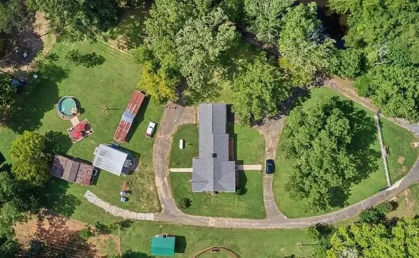 Aerial view of rural North Carolina acreage with homes and woods